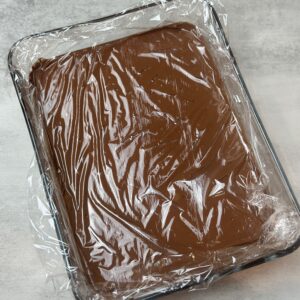 Dark chocolate whipped ganache base covered with plastic wrap before going to the fridge to set for a few hours