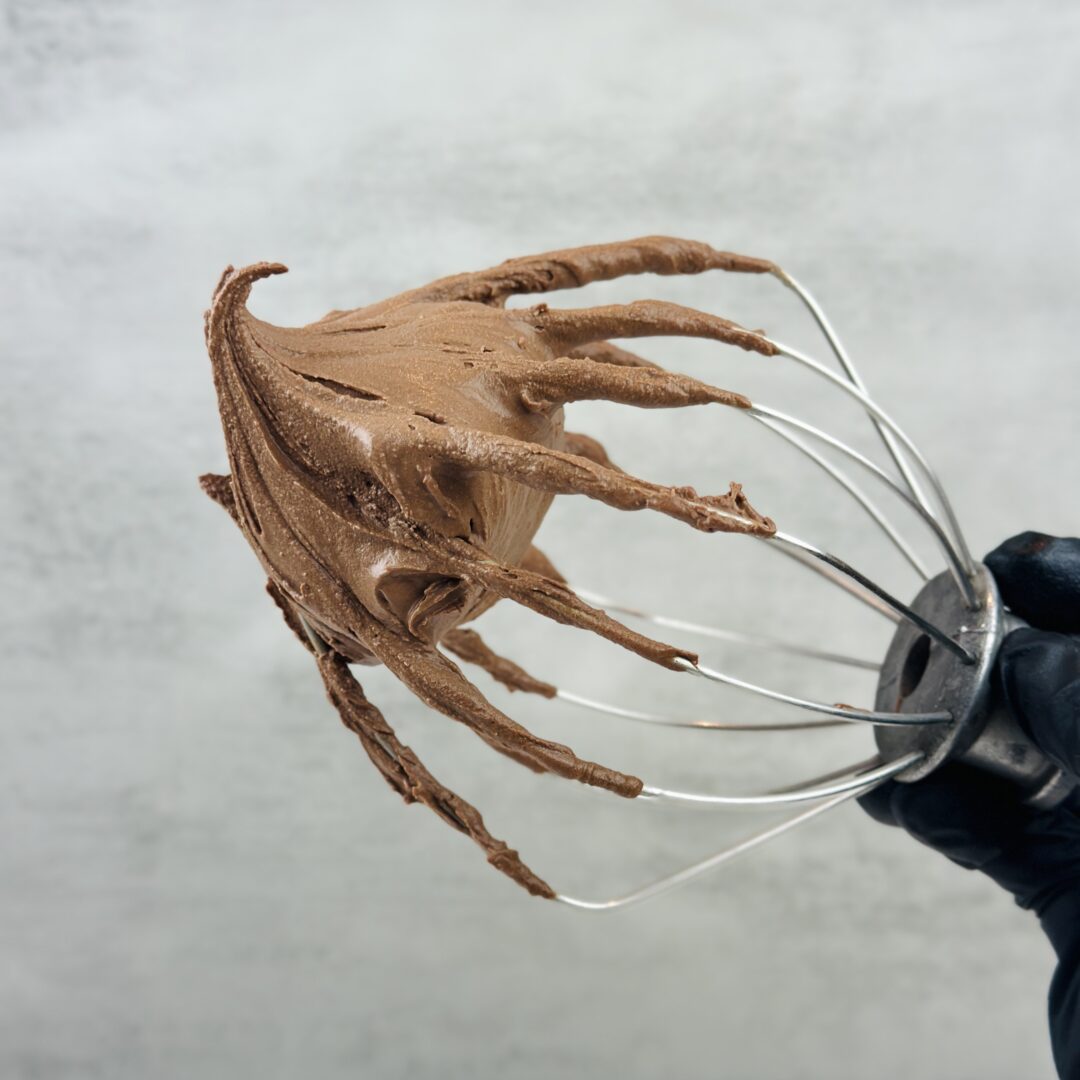 Dark chocolate whipped ganache on a whisk